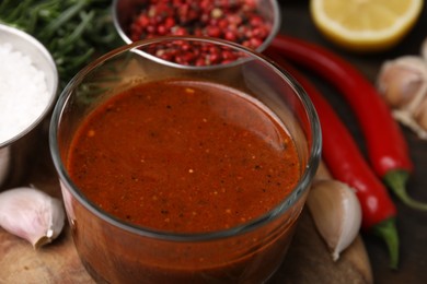 Photo of Fresh marinade and ingredients on wooden table, closeup