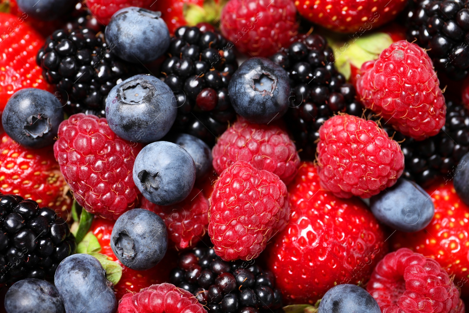 Photo of Many different fresh ripe berries as background, top view