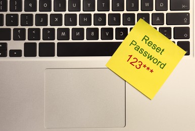 Image of Sticky note with phrase Reset Password on laptop, top view