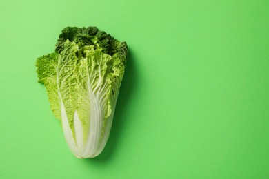 Fresh ripe Chinese cabbage on light green background, top view. Space for text