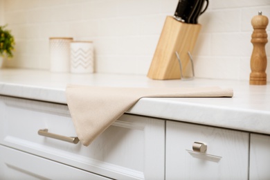 Clean kitchen towel on counter at home, closeup