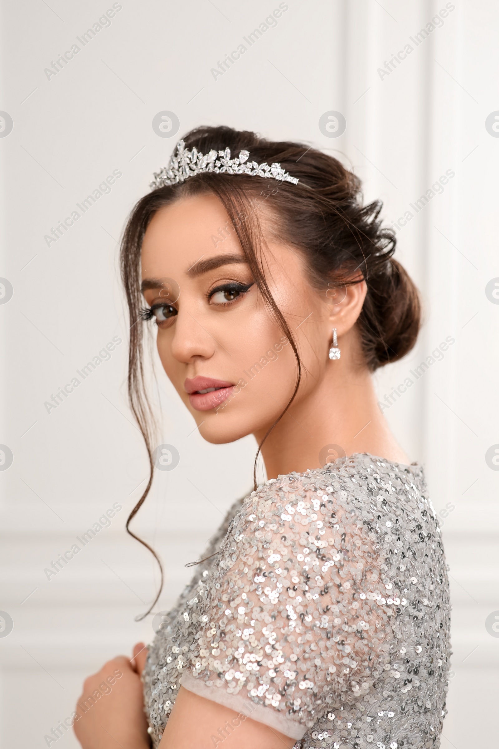 Photo of Beautiful young woman wearing luxurious tiara indoors