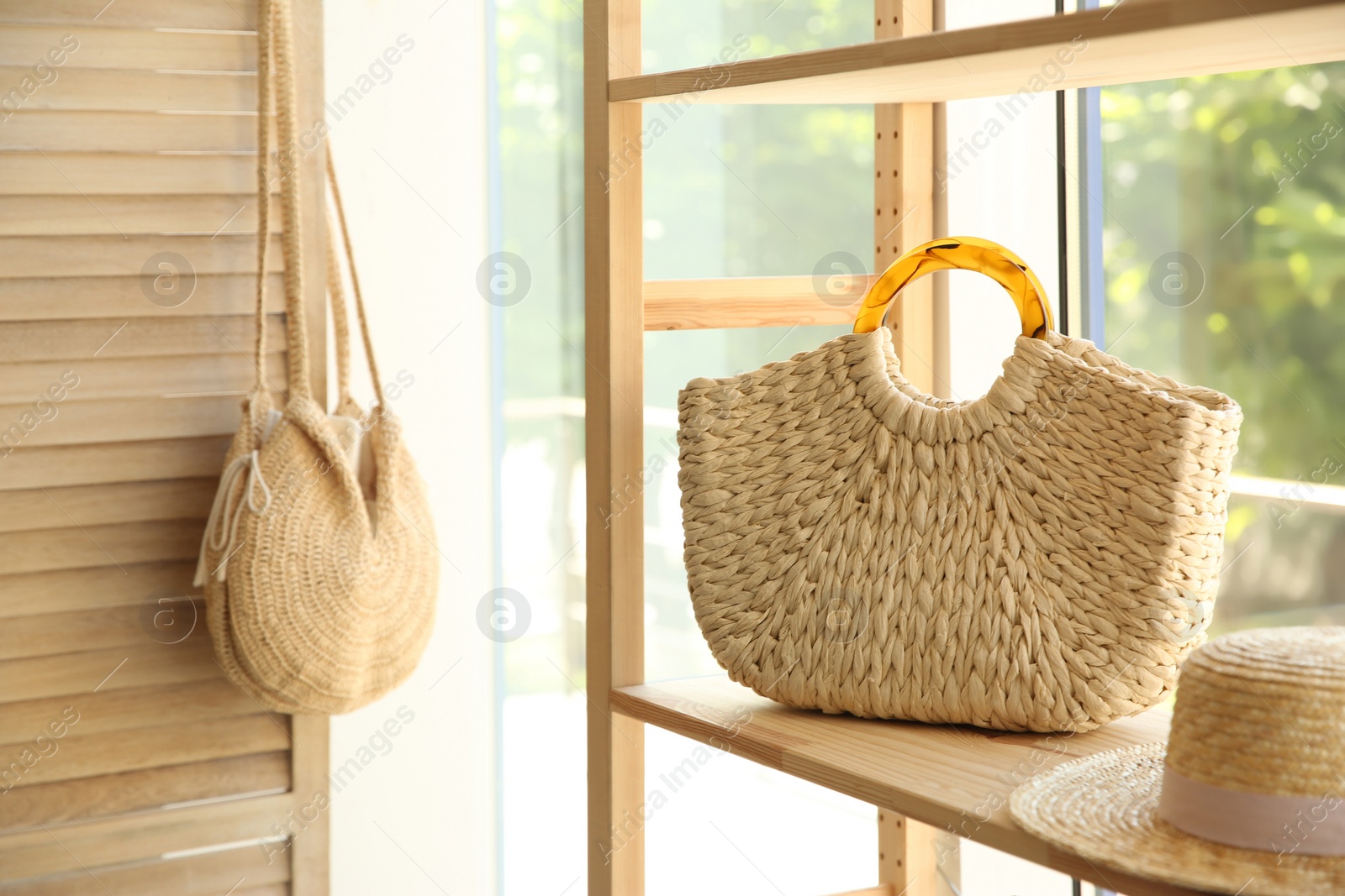 Photo of Stylish knitted woman's bag on shelf in boutique