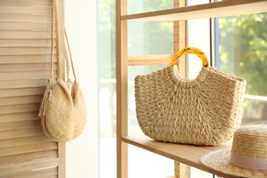 Photo of Stylish knitted woman's bag on shelf in boutique