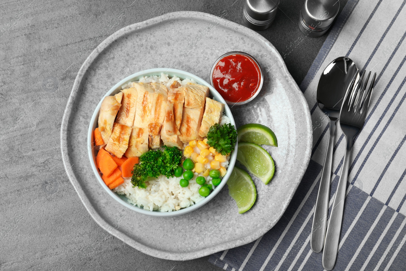 Photo of Boiled rice with vegetables and meat served on table, flat lay