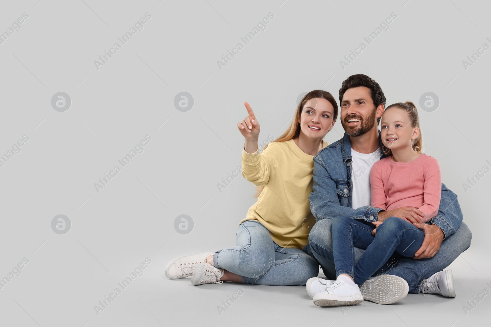 Photo of Happy family on light grey background, space for text