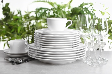 Photo of Set of clean dishes on blurred background