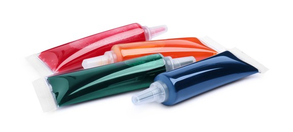 Photo of Tubes with different food coloring on white background