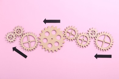 Photo of Business process organization and optimization. Scheme with wooden figures and arrows on pink background, top view