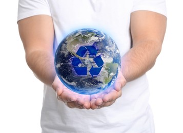 Image of Man holding virtual image of Earth with recycling symbol on white background, closeup view