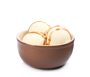 Delicious ice cream with caramel sauce in bowl on white background