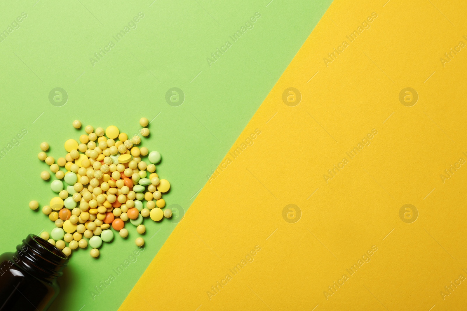 Photo of Bottle with vitamin pills on color background, flat lay. Space for text