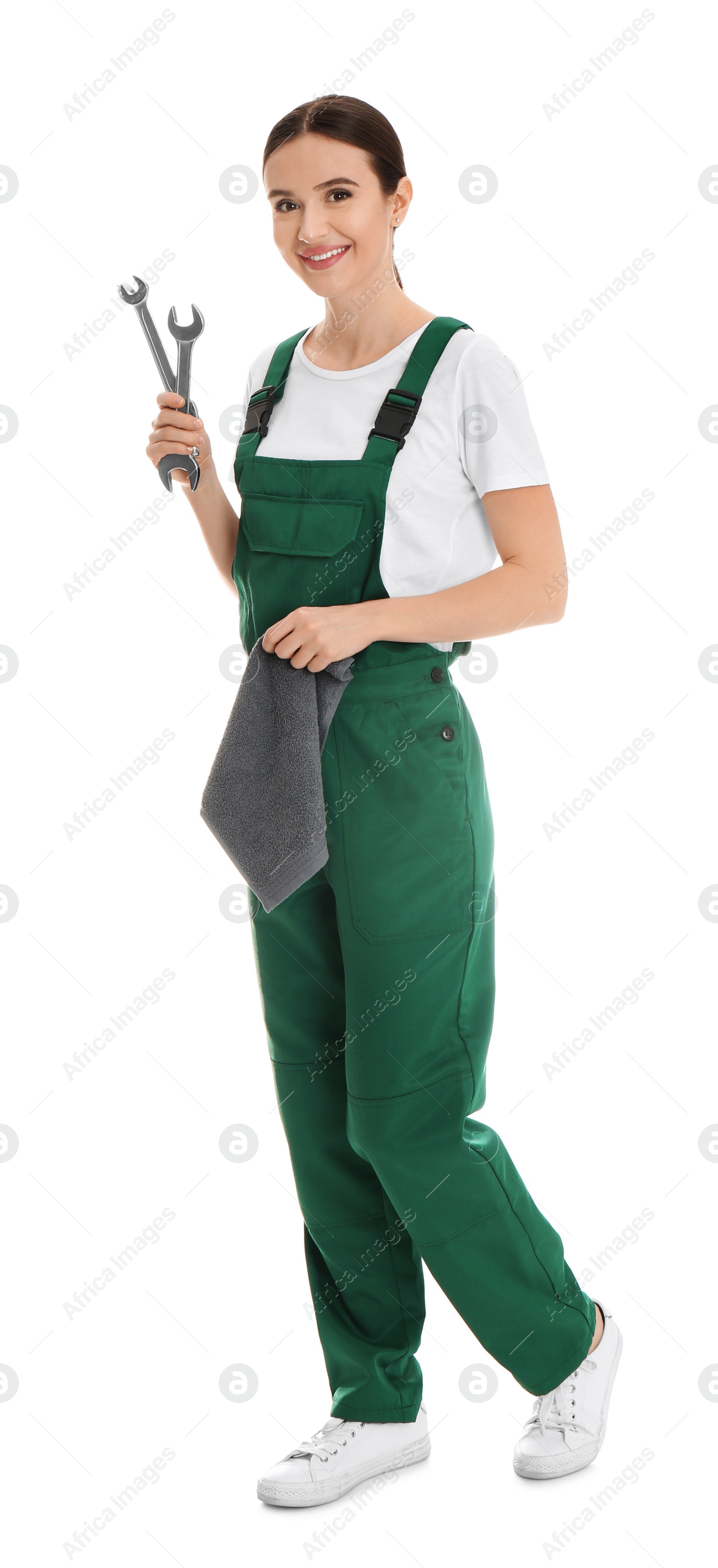 Photo of Full length portrait of professional auto mechanic with wrenches and rag on white background