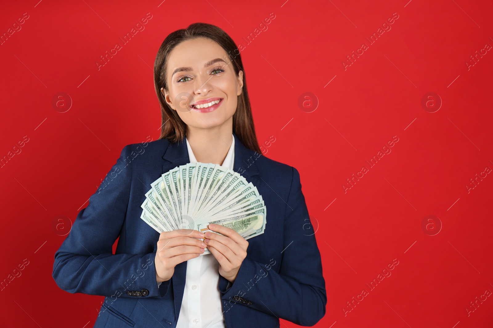 Photo of Young woman with money on crimson background. Space for text