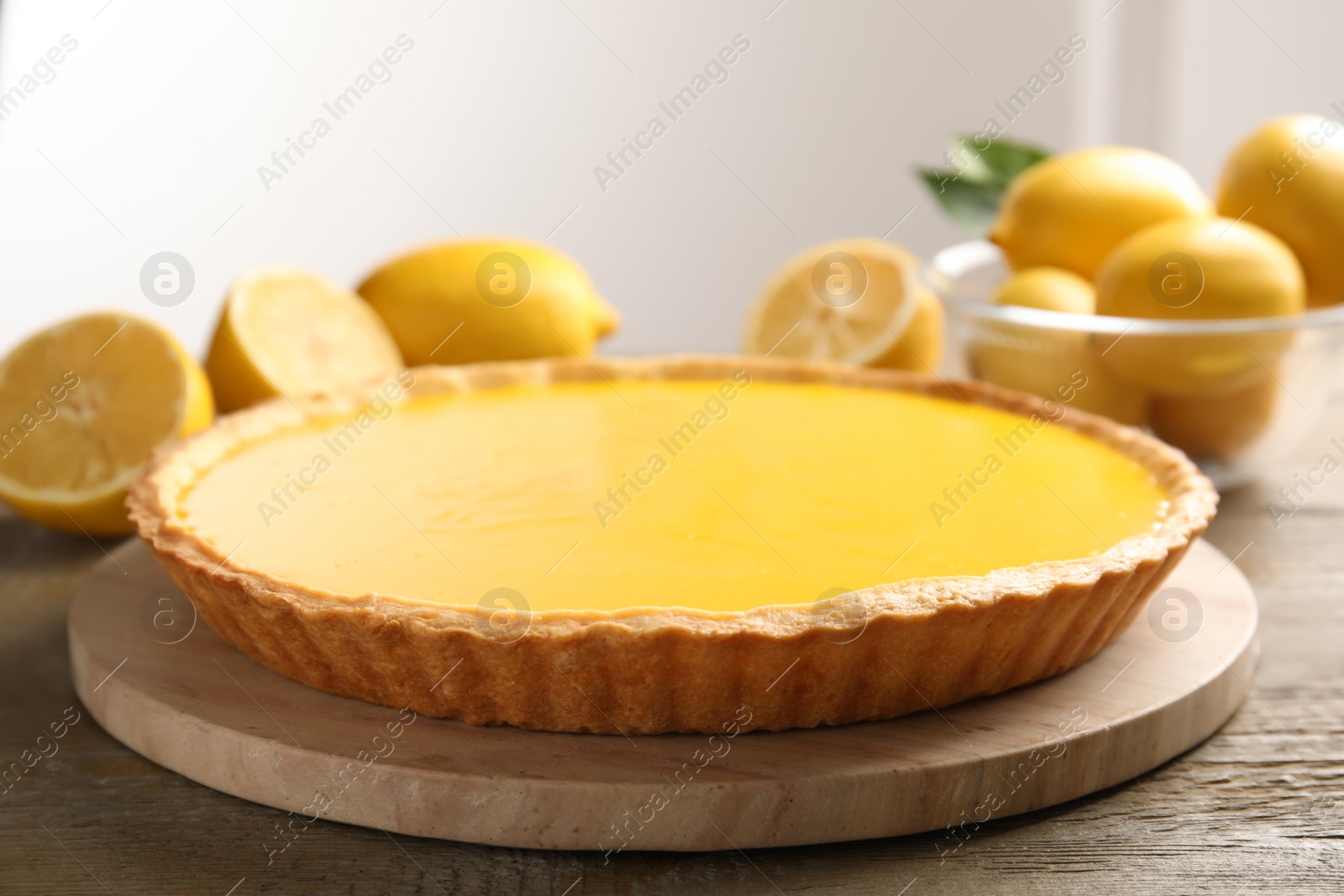 Photo of Delicious homemade lemon pie with mint on wooden table