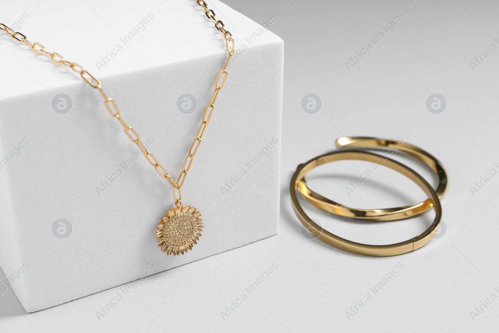 Photo of Stylish presentation of necklace and bracelets on white background