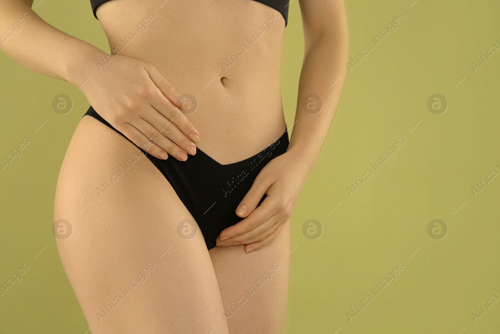 Photo of Gynecology. Woman in underwear on green background, closeup. Space for text