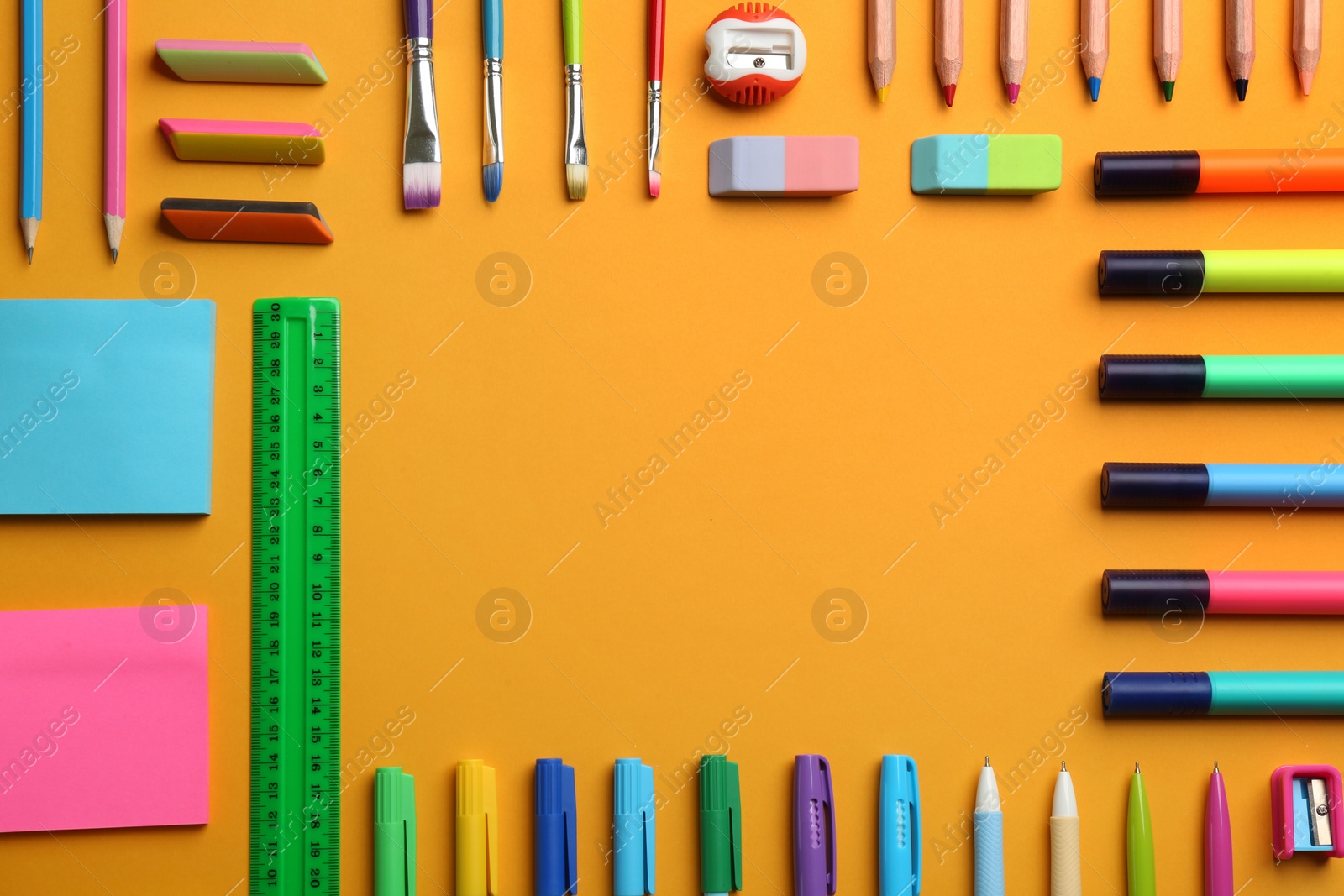 Photo of Frame of school stationery on orange background, flat lay with space for text. Back to school