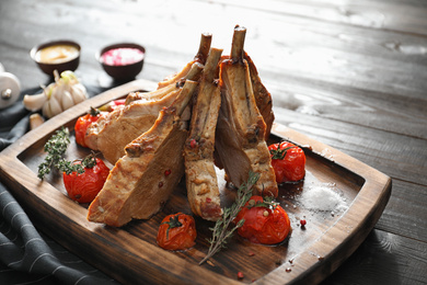 Delicious roasted ribs with served on wooden table, closeup