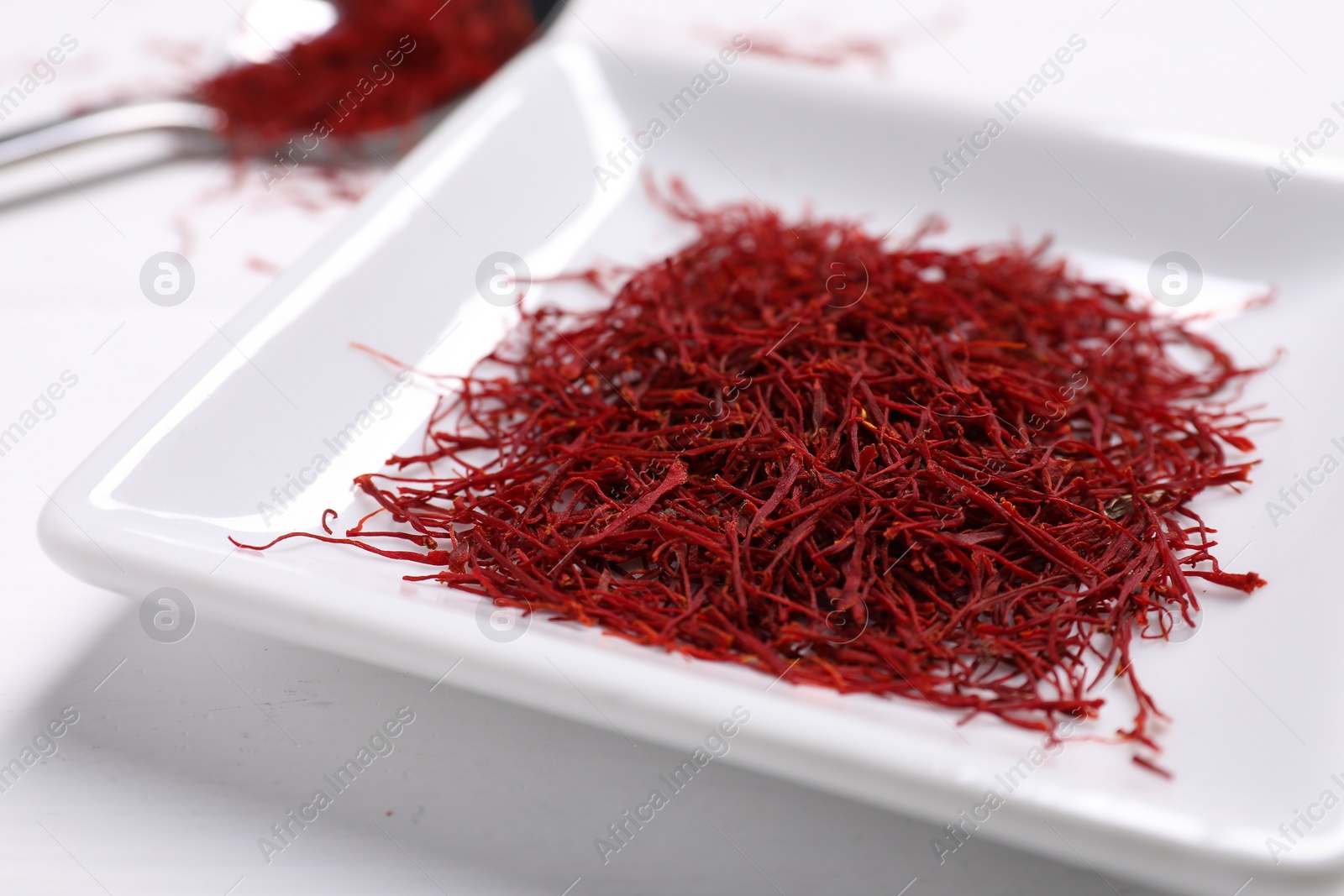 Photo of Aromatic saffron on white table, closeup view