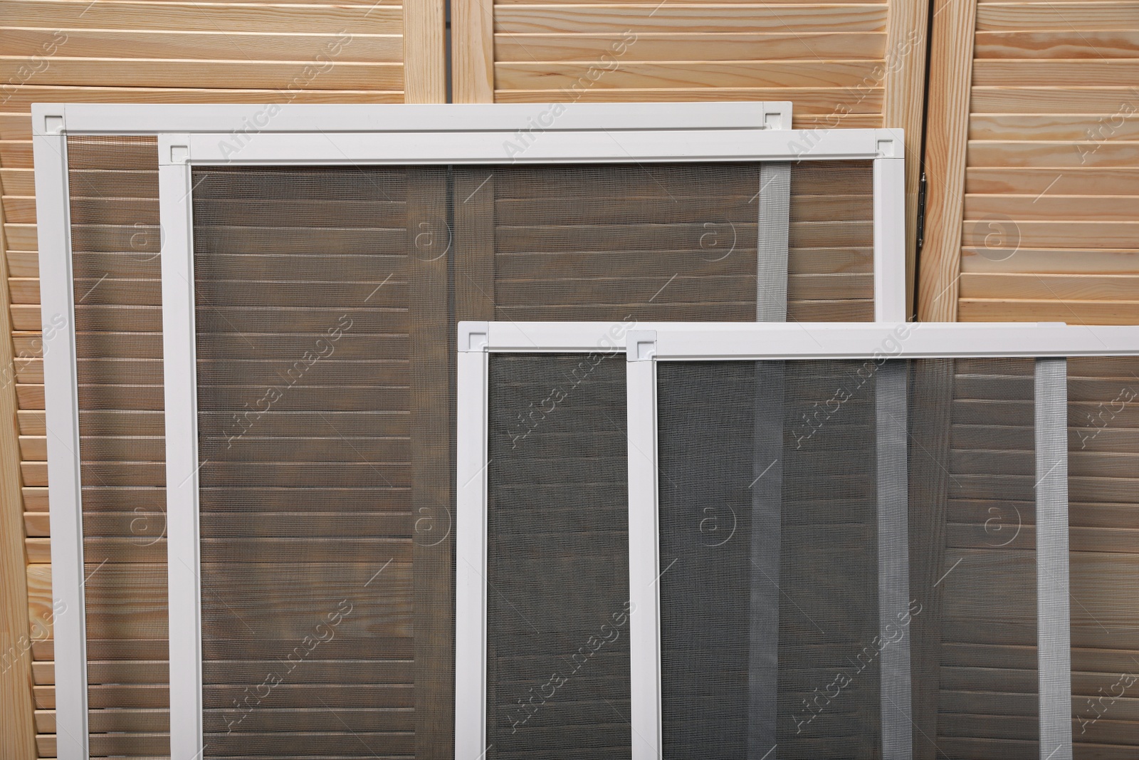 Photo of Set of window screens near wooden folding screen