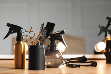 Photo of Set of hairdresser tools on table in salon, space for text