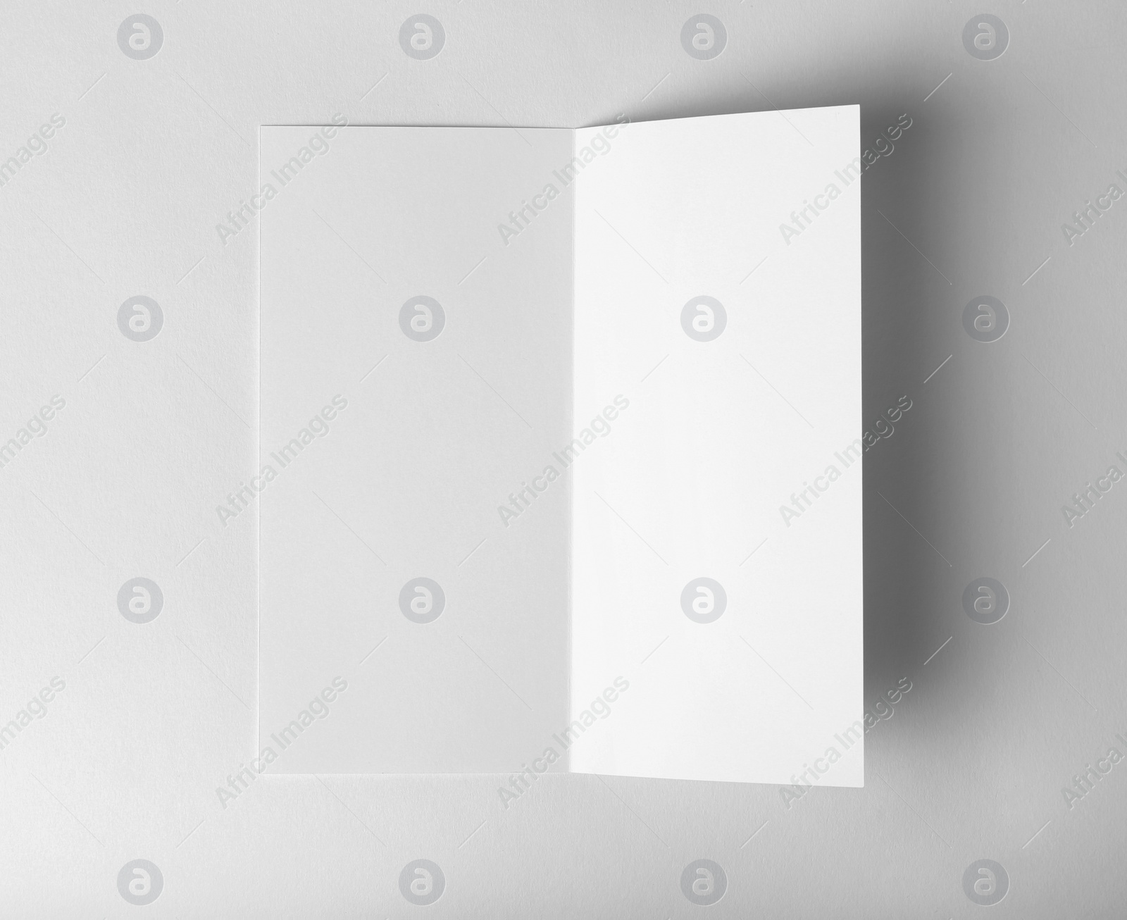 Photo of Blank brochure mock up on white background, top view