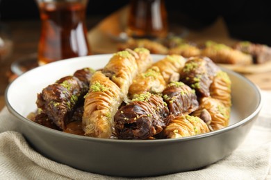 Delicious sweet baklava in bowl on table, closeup