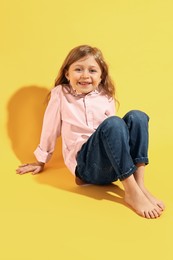 Fashion concept. Stylish girl posing on yellow background