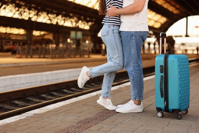 Photo of Long-distance relationship. Couple on platform of railway station, closeup