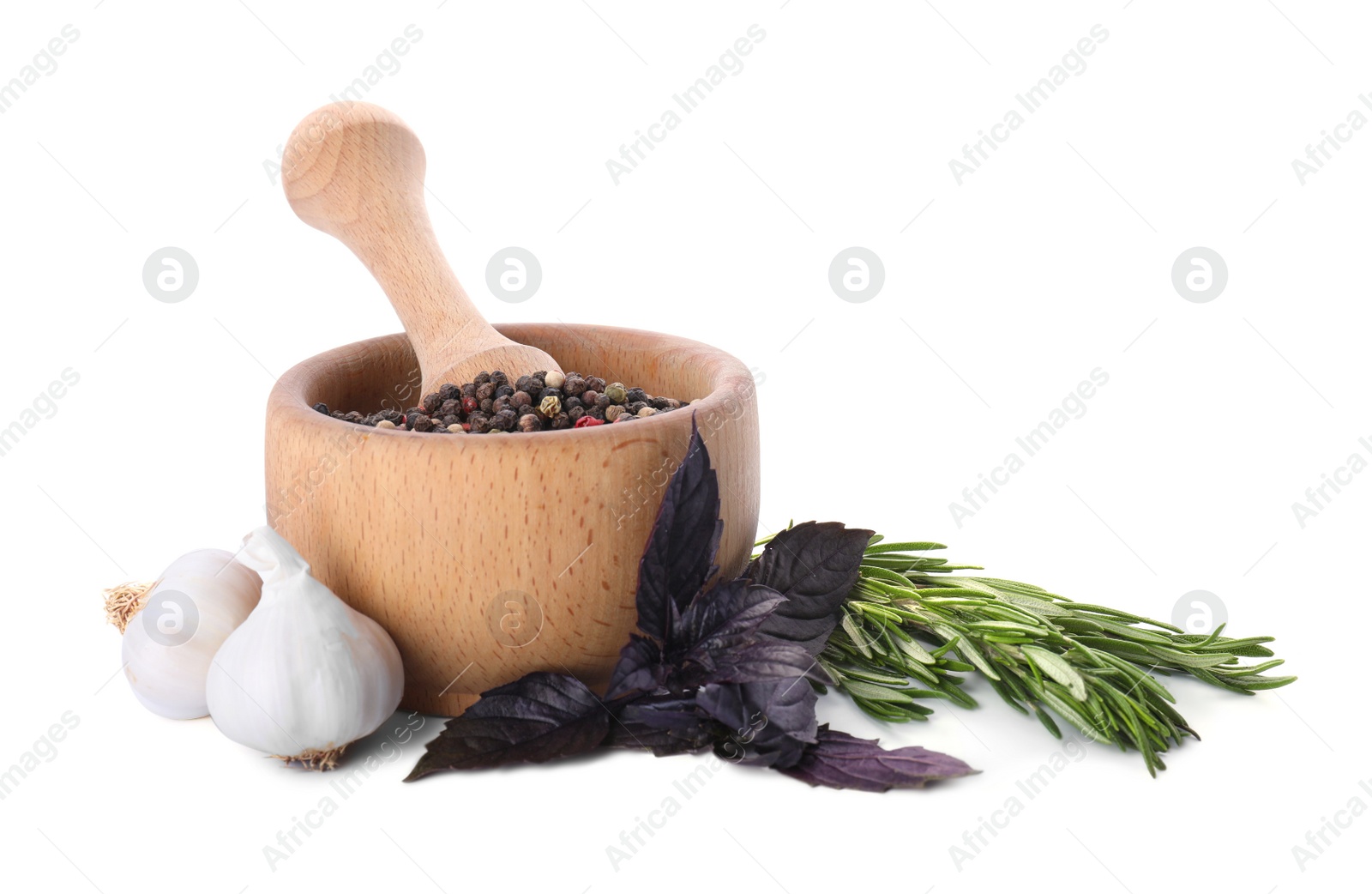 Photo of Mortar with pestle and different spices on white background