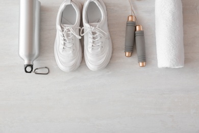 Photo of Flat lay composition with fitness equipment and space for text on gray background