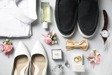Photo of Wedding stuff. Flat lay composition with stylish boutonniere on light gray background