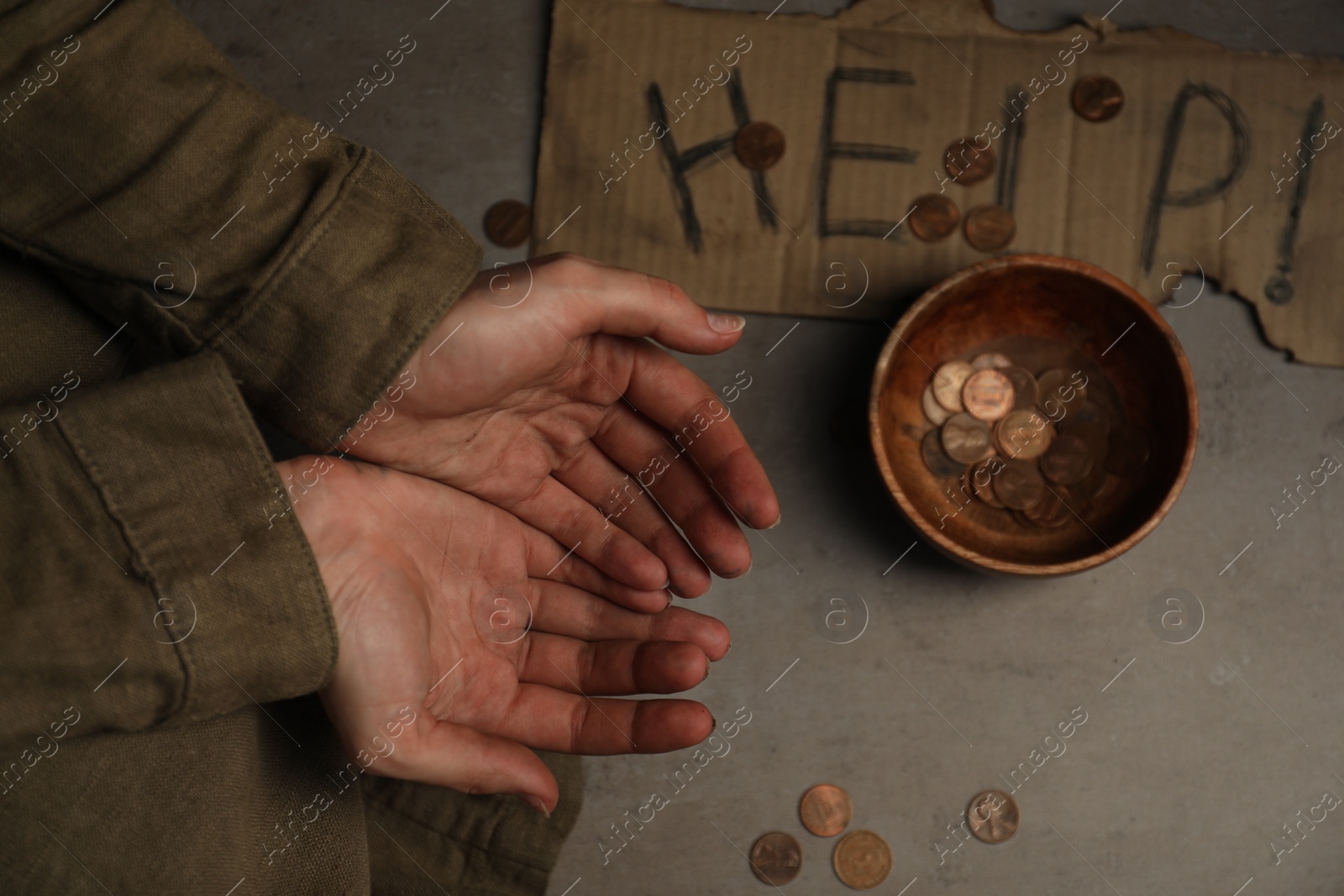 Photo of Poor homeless woman begging for money. Cardboard help sign and bowl with donations near her, top view