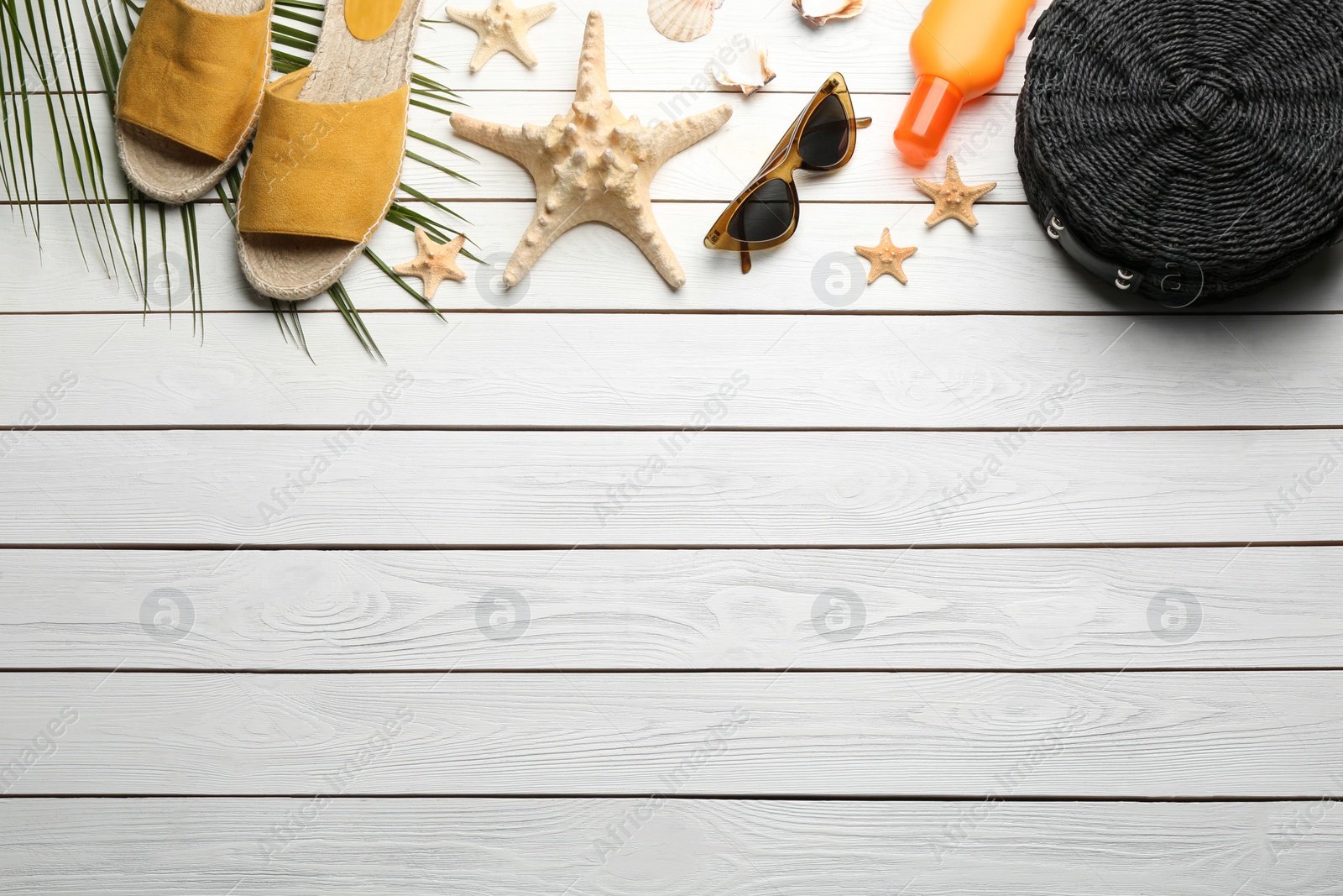 Photo of Beach accessories on white wooden background, flat lay. Space for text