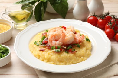 Plate with fresh tasty shrimps, bacon, grits, green onion and pepper on wooden table, closeup