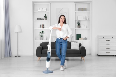 Photo of Happy woman with steam mop at home