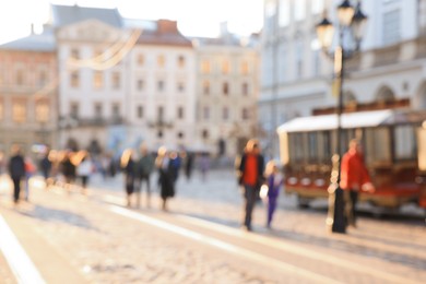 Photo of Blurred view of people walking on city street