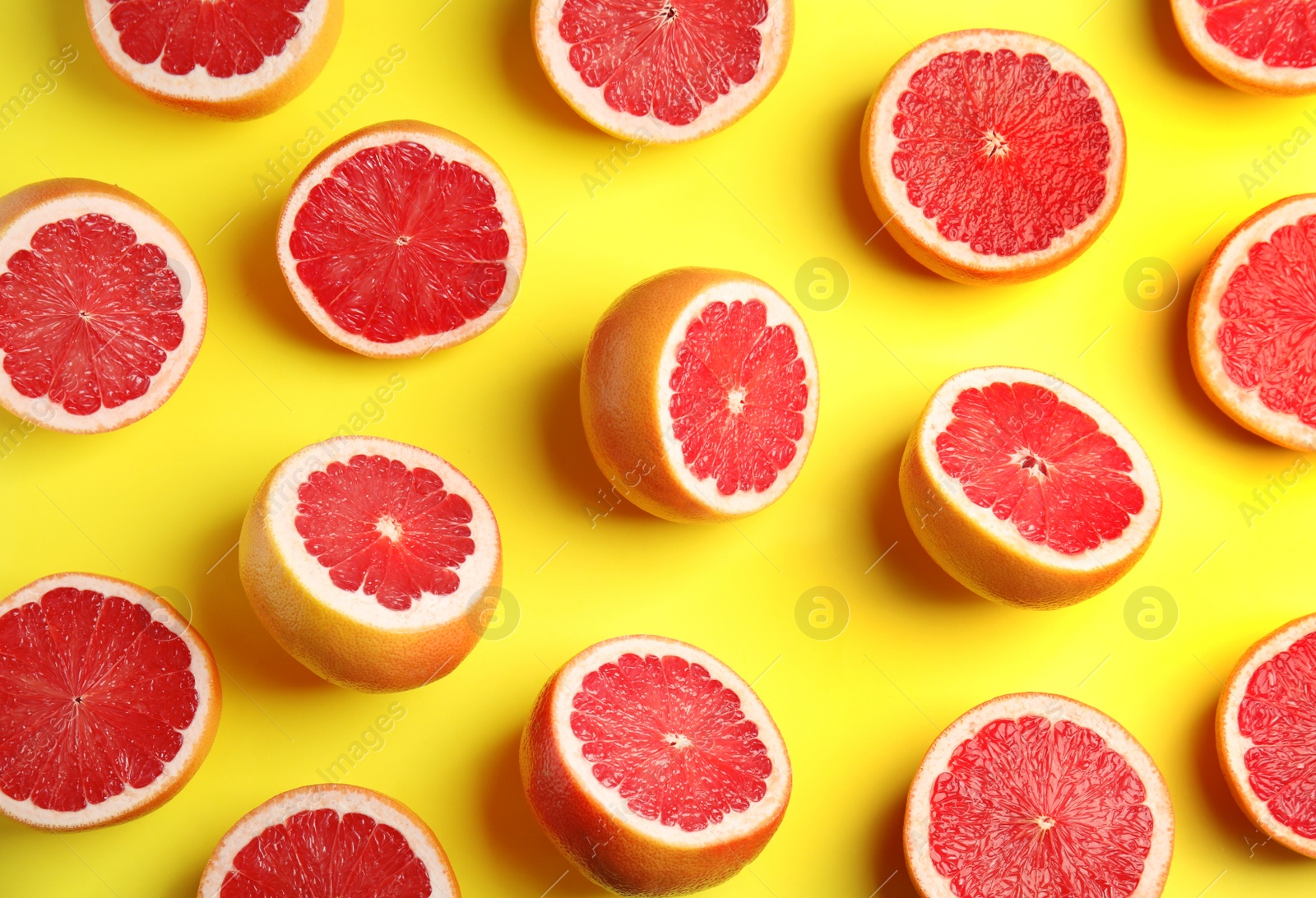 Photo of Fresh sliced ripe grapefruits on color background, flat lay