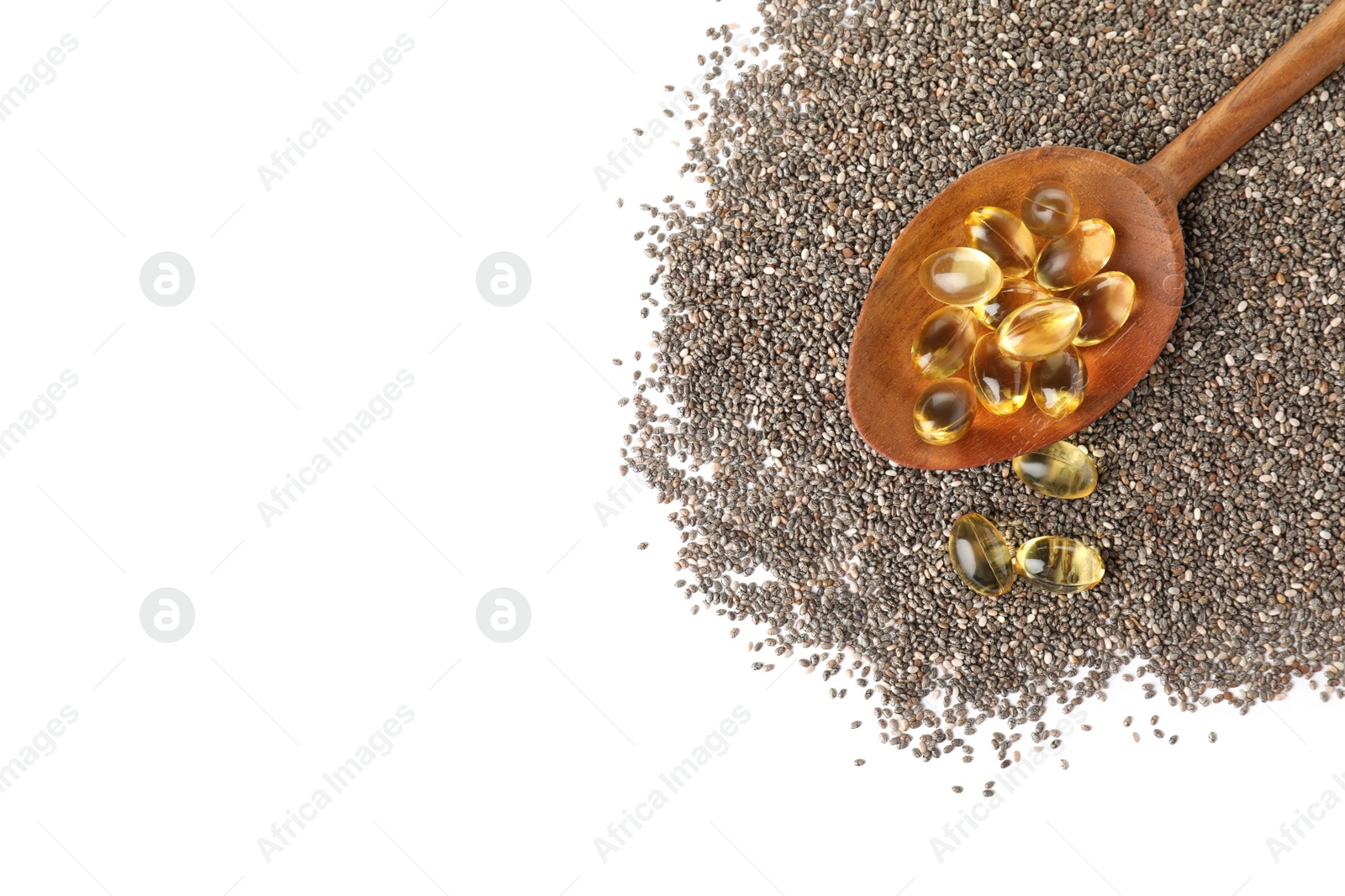 Photo of Spoon with chia oil capsules and seeds on white background, top view