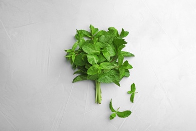 Bunch of fresh mint on grey background, top view