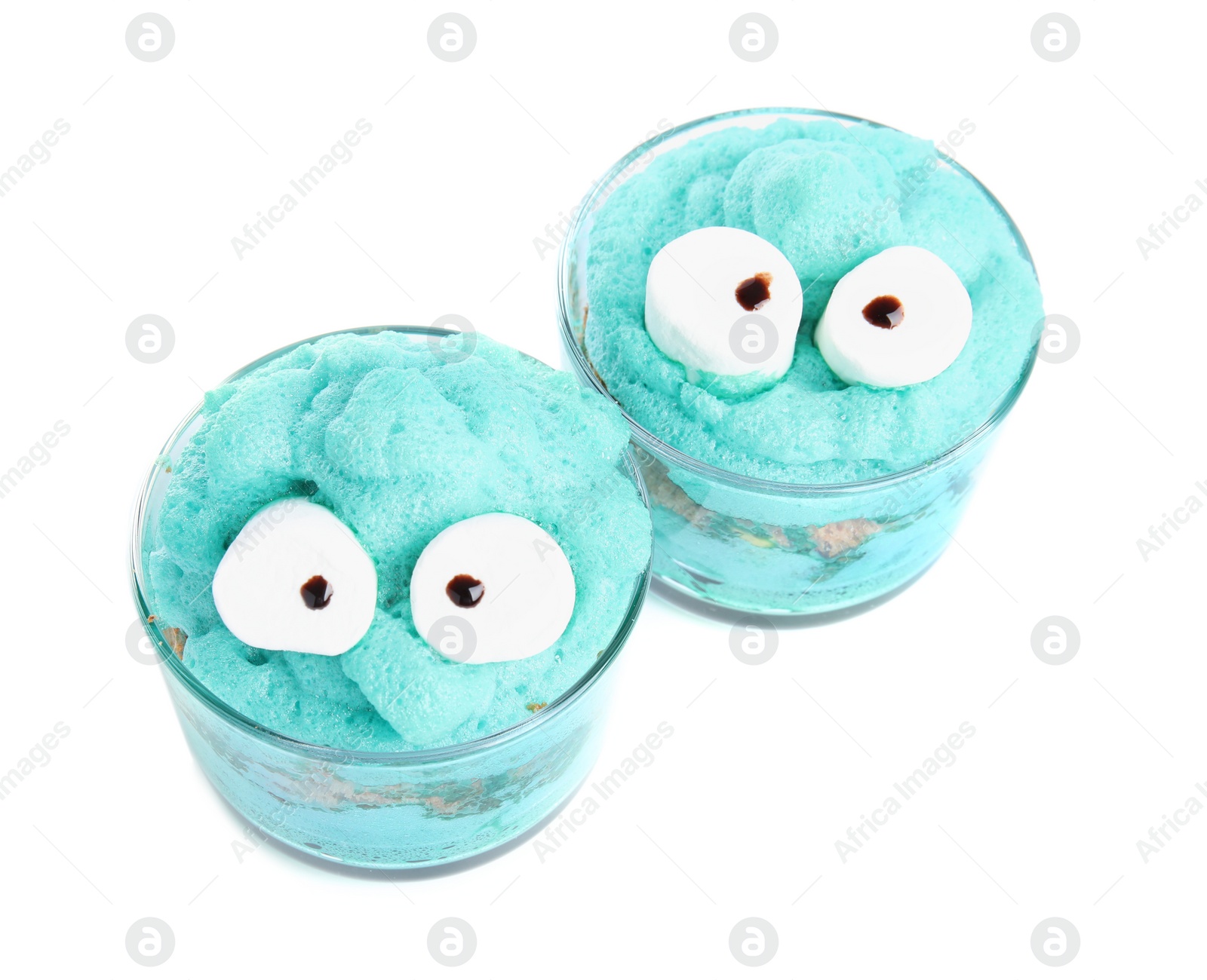 Photo of Delicious desserts decorated as monsters on white background. Halloween treat