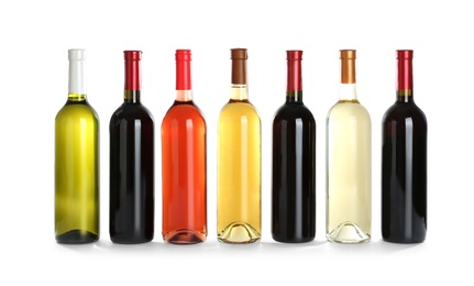 Bottles with different wine on white background