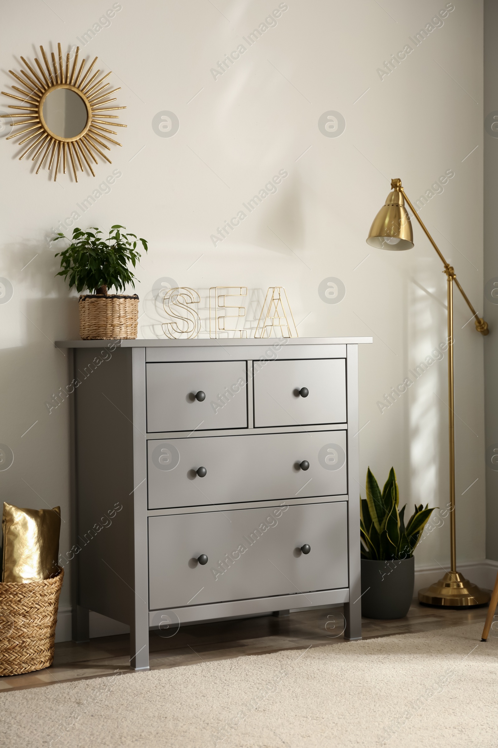 Photo of Grey chest of drawers in stylish room interior