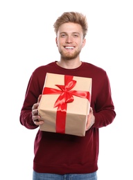 Young man with Christmas gift on white background