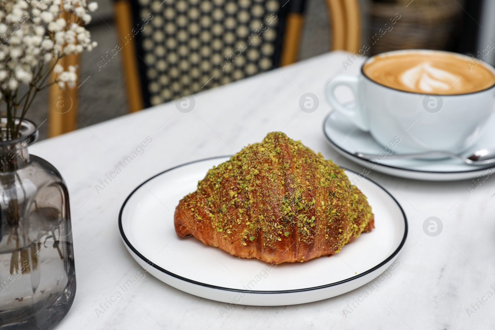 Photo of Delicious croissant and coffee on white marble table