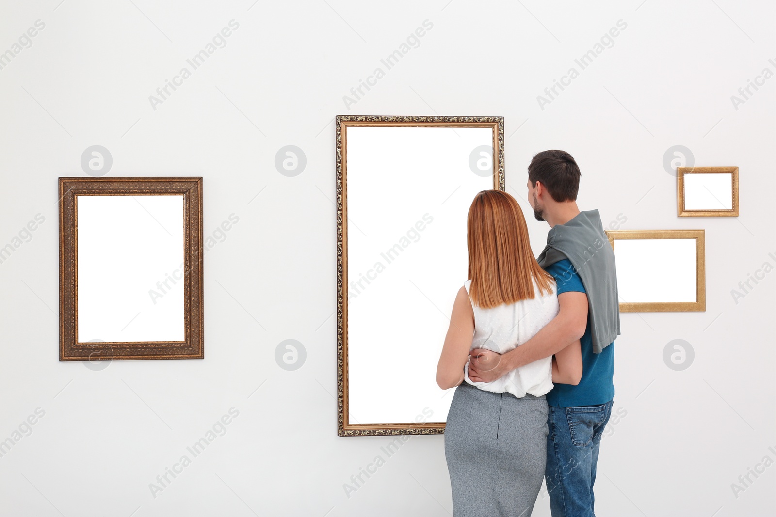 Photo of Couple viewing exposition in modern art gallery