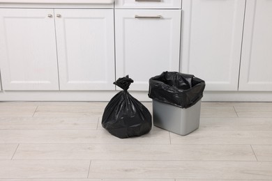 Photo of Plastic garbage bag and trash can indoors