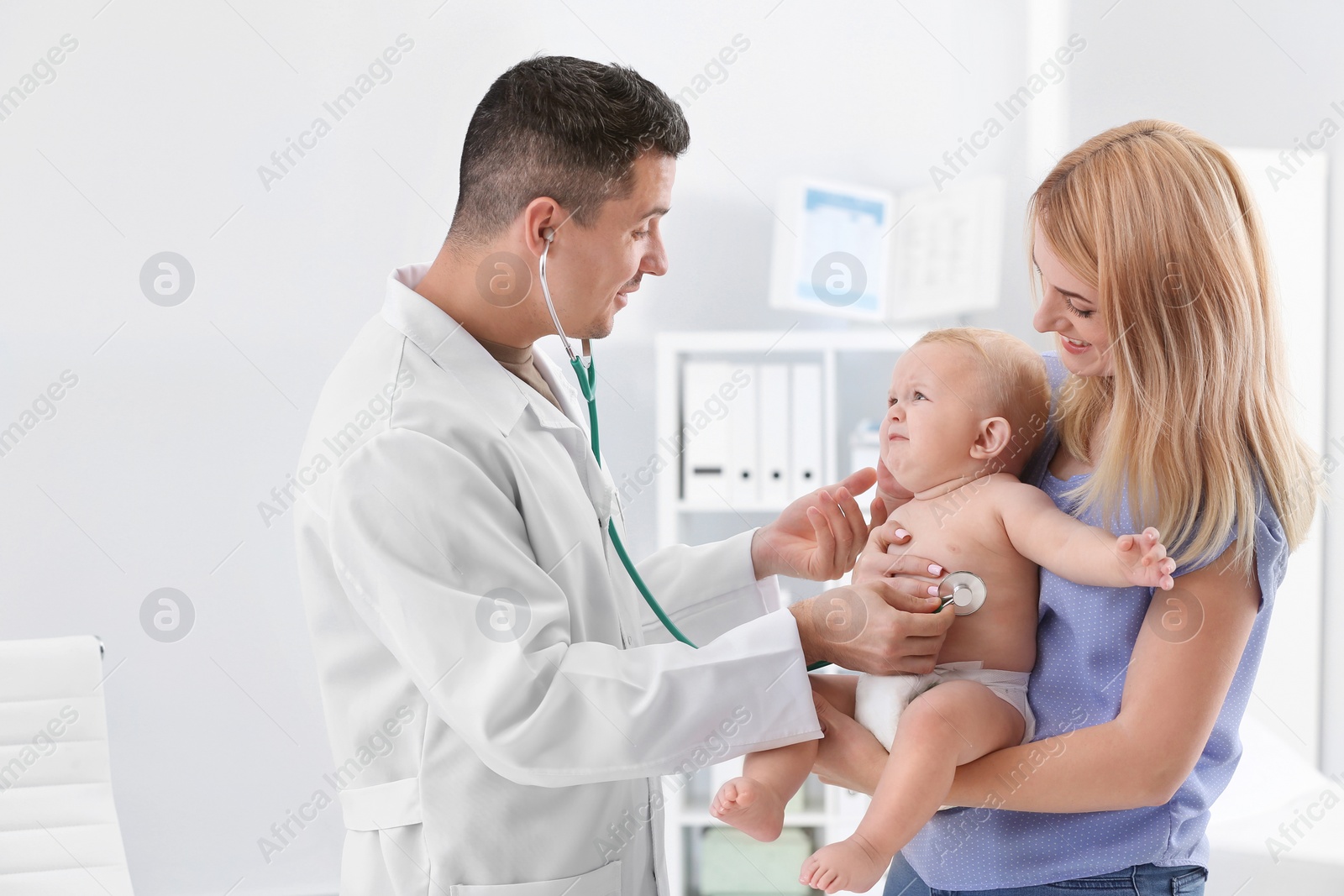 Photo of Woman with her baby visiting children's doctor in hospital