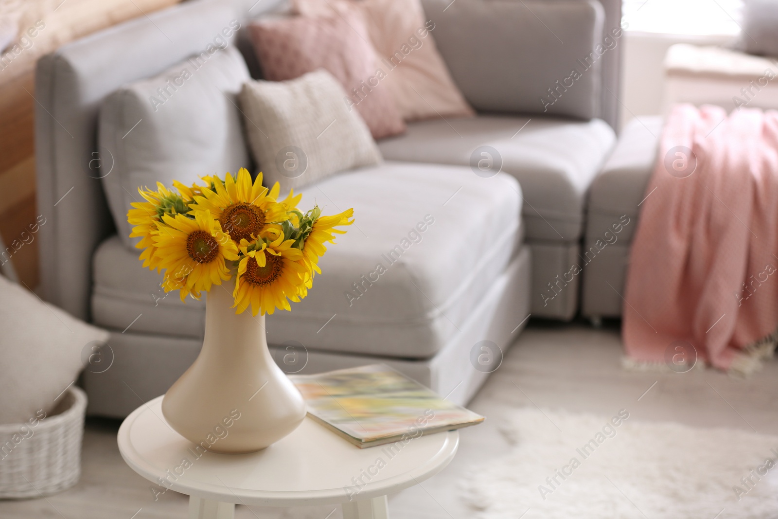 Photo of Beautiful bouquet of sunflowers in vase on white table indoors. Space for text